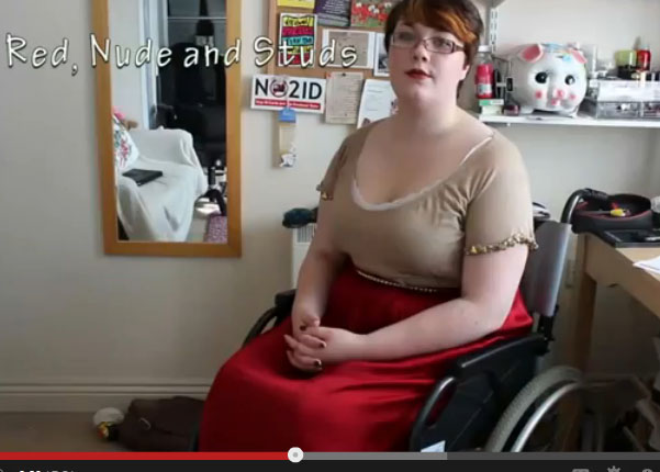 Woman in her chair demonstrating the style "Red, Nude, and Studs"